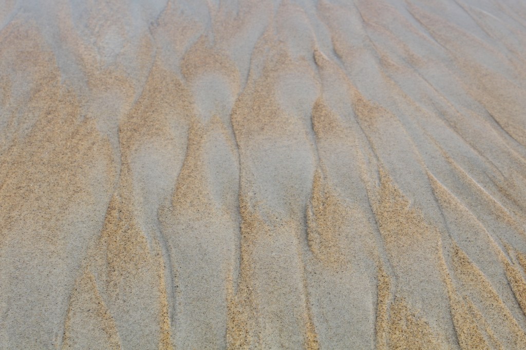 Patterns in the sand created by wave action